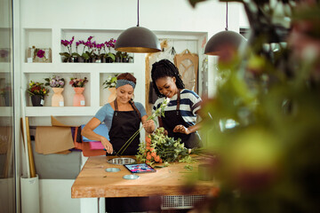 Female florists making bouquet in flower store
