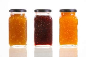 orange marmalade, raspberry jam and ginger lemon canned in glass jar isolated mockup template. sweet food dessert