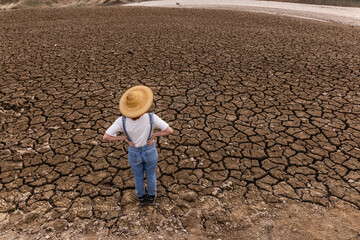 People in middle of dry field, weather problems, drought