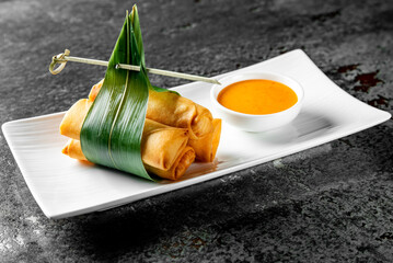 traditional vietnamese nems or deep fried spring rolls and dipping sauces