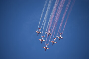 Airshow of aerobatic planes showcasing parachutes paramotor skydiving show with colors  