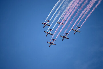 Airshow of aerobatic planes showcasing parachutes paramotor skydiving show with colors  