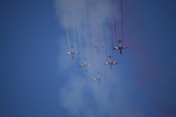 Airshow of aerobatic planes showcasing parachutes paramotor skydiving show with colors  