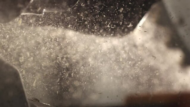 4k Highspeed shot of sawdust floating n the air in a carpentry