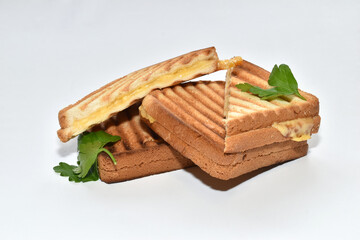 Several toasted cheese sandwiches lie on a white background.