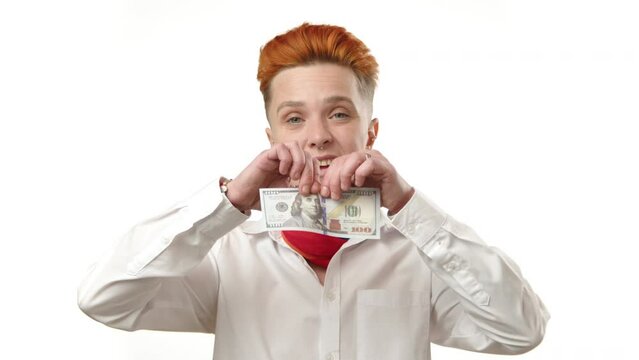In a striking display of financial rebellion, a young lesbian woman tears up a hundred-dollar bill, challenging traditional norms of economic value and personal wealth. High quality 4k footage