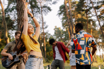 Multiracial group of people, beautiful hipster woman dancing on the background of friends having fun