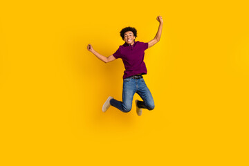 Fototapeta na wymiar Full length photo of glad funny good mood guy wear trendy violet outfit rejoice special sale isolated on yellow color background