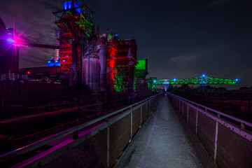 Illuminated steel factory at night.