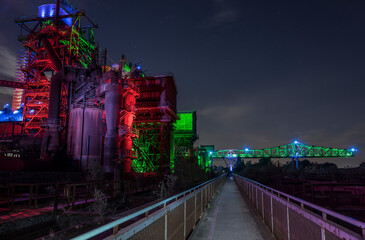 Illuminated steel factory at night.