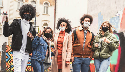Happy young group of multiethnic friends wearing face mask.