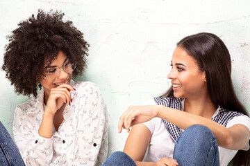 Two beautiful african american girls looking at eachother with smile. - 731318115