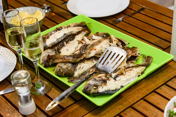 Grilled sea fish served with white wine