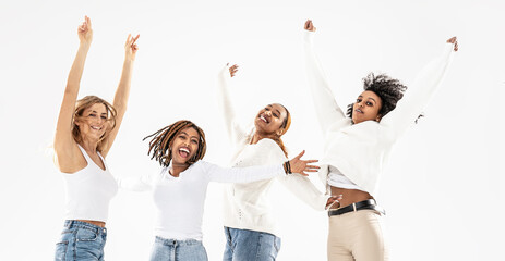 Naklejka premium Four millennial multiethnic girlfriends jumping and laughing