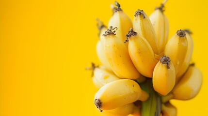 Fresh mini bananas bunch on vibrant yellow background. perfect for healthy lifestyle promotion. bright and appealing fruit display. AI - obrazy, fototapety, plakaty