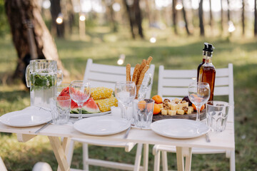 Decor in boho style. Picnic in the nature, table. Holidays in the nature concept.