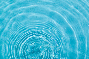 drops on water with circles on a blue background