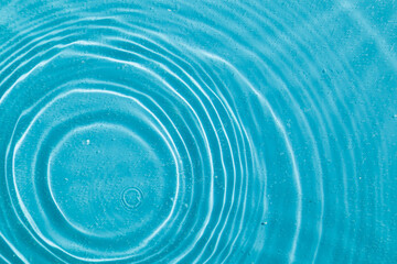 drops on water with circles on a blue background