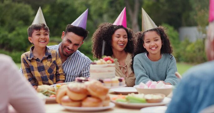 Children, parents and happy with hat at birthday party for celebration, laughing or memories in garden of home. Family, couple and kids with enjoyment for funny joke, gathering and event in backyard