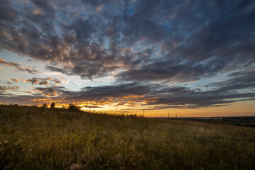 Dramatic sunset in the countryside with river and skyline views