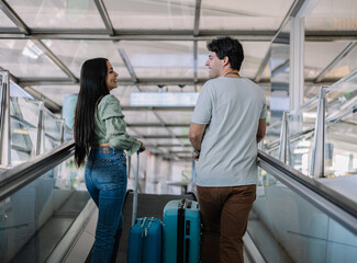 couple of loving travelers arriving at the airport to enjoy their honeymoon