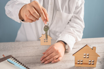 House keys in woman's hand, concept of home buying and selling service