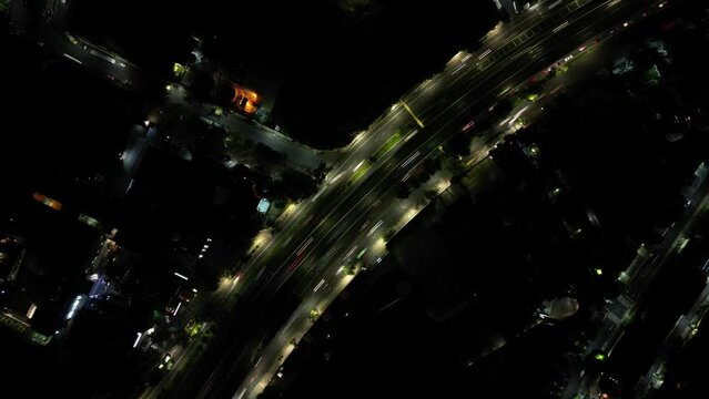 Ascending timelapse drone footage of cars on the street in Mexico City at night