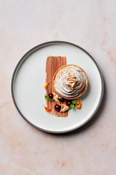 Frangipane & blackcurrant tart with chestnut cremeux and almond slivers, from above