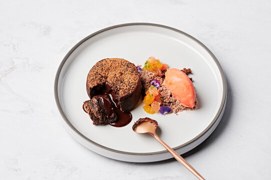 Warm chocolate fondant, Cointreau citrus segments, gianduja snow, blood orange sorbet