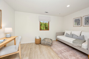 the room has white walls and wood floors and is decorated in a calming tone