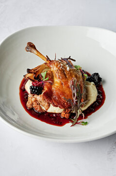 Roasted, confit duck leg, parsnip puree, spiced pork & fennel seed chipolata, roasted fennel bulb, duck jus, boysenberries