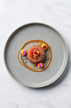 Dairy free chocolate mousse, mandarin curd, salted caramel, cacao nib praline