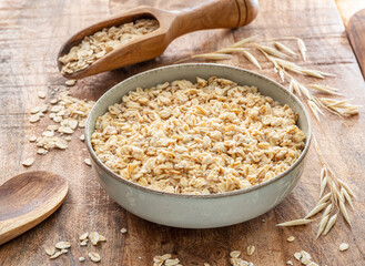 Bowl of porridge or oatmeal on wooden table.