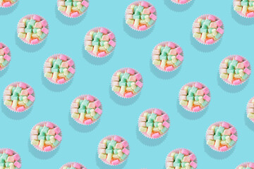Modern retro color theme pattern of pastel candies against an aqua blue background.