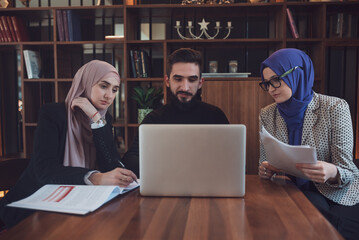 Business team of a two Muslim woman and man working together in the office.