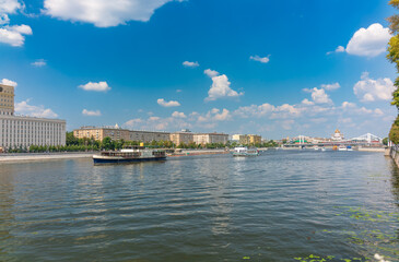 Obraz premium Cruise ship sails on the Moscow river in Moscow city center, popular place for walking.