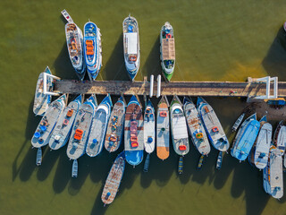 Aerial drone view showcasing boats neatly lined along the pier on the Tapajos river in Santarem, Brazil