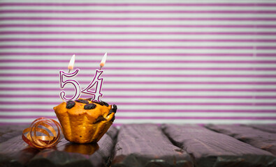 Birthday number 54. Date of birth with number of candles, copy space. Anniversary background with...