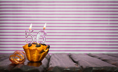Birthday number 56. Date of birth with number of candles, copy space. Anniversary background with...