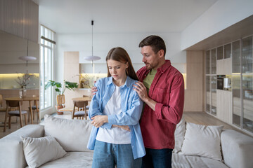 Considerate husband caring of gloomy distressed wife, hugging gently, consoling sad woman. Loving empathic man giving emotional support, comfort, consolation to woman in difficult family situations