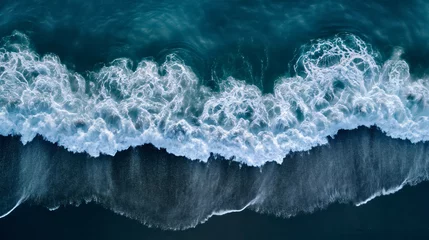 Fototapeten Aerial drone view or top view perspective photography of a beautiful transparent clear sea or ocean waves and foam splashing on the dark navvy blue or gray sand beach  © Nemanja