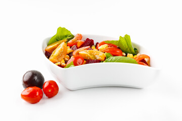 Salad with corn, tomatoes and olives in a white bowl