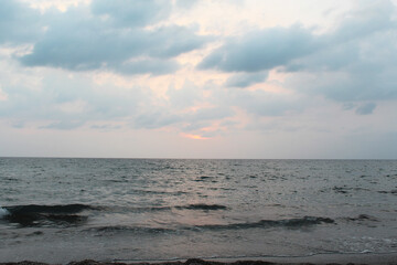 natural background of evening blue sky with pink sunset over the ocean