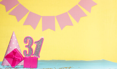 Date of birth for a girl  31. Copy space. Birthday in pink shades with a yellow background....