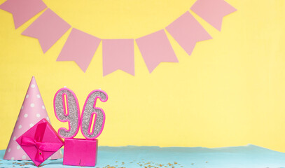 Date of birth for a girl  96. Copy space. Birthday in pink shades with a yellow background....