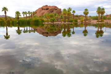 Papago park, hole in the ricks reflection in the water on a cloudy day, in Phoenix, Arizona. 