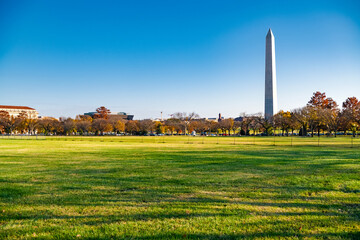 The Washington Monument in Washington, DC on an autumn day against a blue sky.