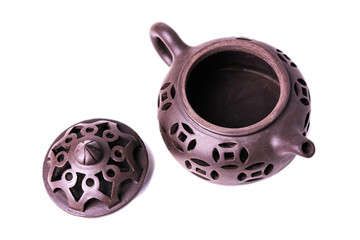 Clay teapot with carved patterns with an open lid isolated on white background.