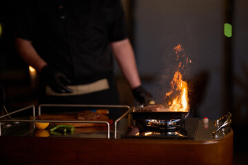 Close-up shot, a professional chef expertly prepares a delicious steak using modern cooking techniques, showcasing culinary excellence and precision in the art of gourmet cuisine