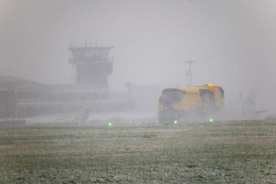 Leeds Bradford Airport LBA in snowy conditions as snow plough and gritters work